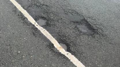 Potholes 'painted over' by council with road markings in Mold